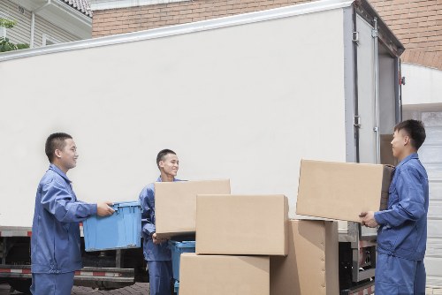 Local removals team handling furniture in Roehampton street