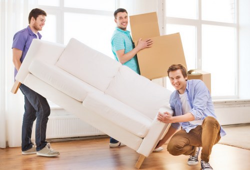 Professional movers transporting items from a Roehampton flat