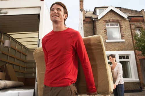 Local removals crew transporting furniture safely through a Roehampton property
