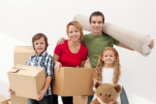 Workers loading furniture into a removal vehicle safely
