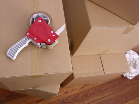 Careful packing of fragile items during a Roehampton house move