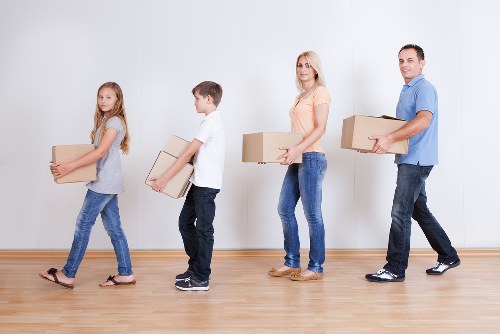 Professional flat removal team handling boxes in a Roehampton apartment building