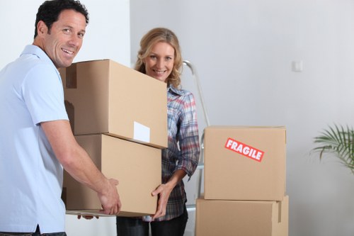 Moving boxes and furniture placed in a new Roehampton home after delivery
